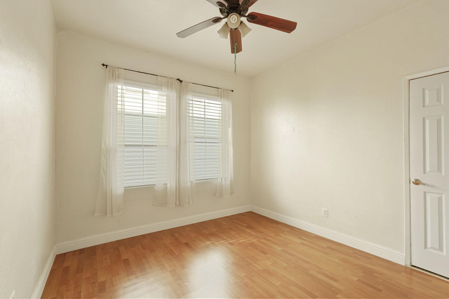 715 North Sutter Street Stockton, CA 95202 - Photo 13 of 51 a view of empty room with wooden floor and fan