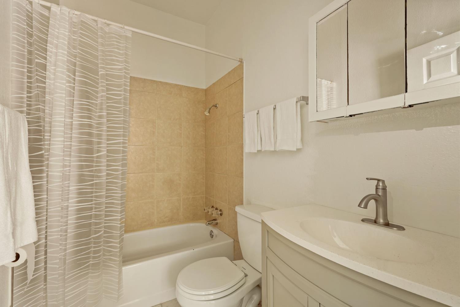 715 North Sutter Street Stockton, CA 95202 - Photo 16 of 51 a bathroom with a sink a toilet and bathtub