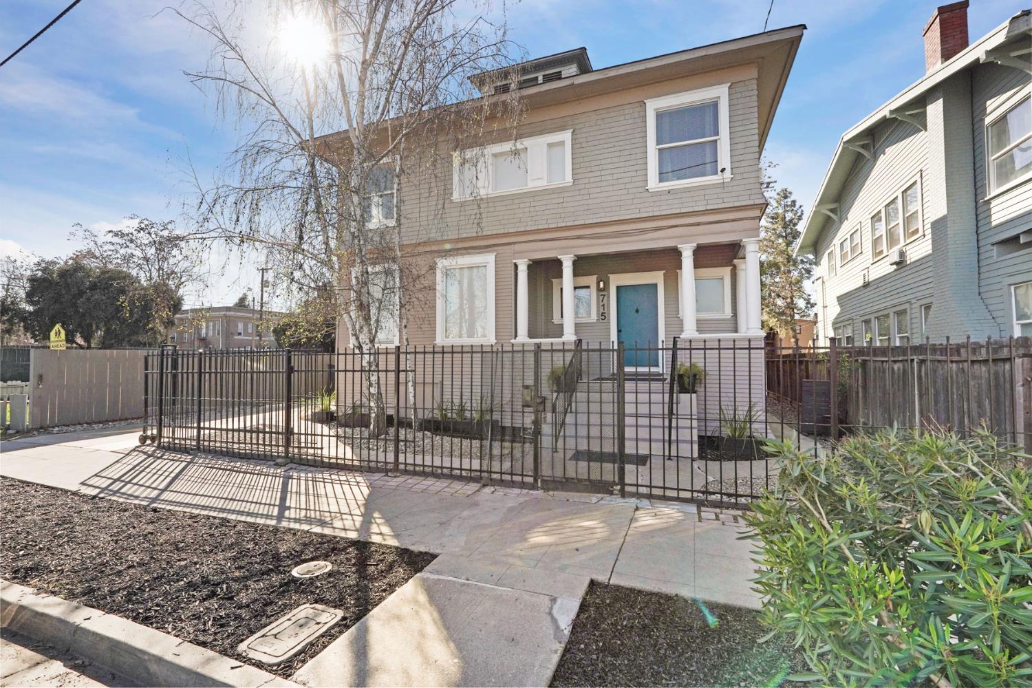 715 North Sutter Street Stockton, CA 95202 - Photo 2 of 51 a view of a brick house with a small yard and wooden fence