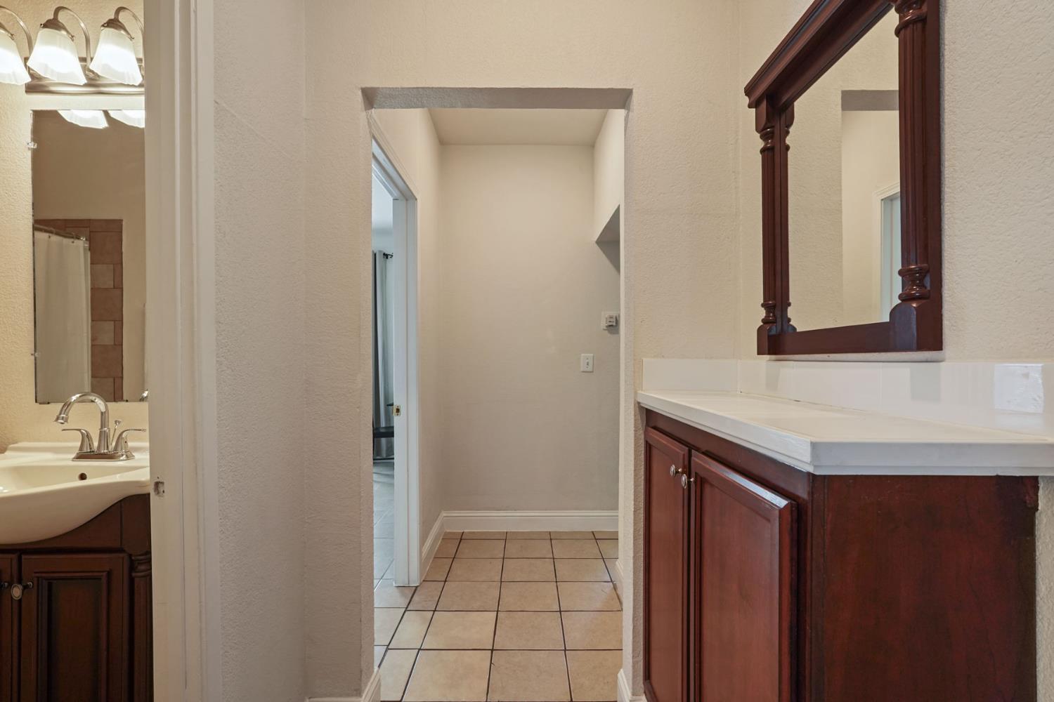 715 North Sutter Street Stockton, CA 95202 - Photo 32 of 51 a bathroom with a sink and a mirror