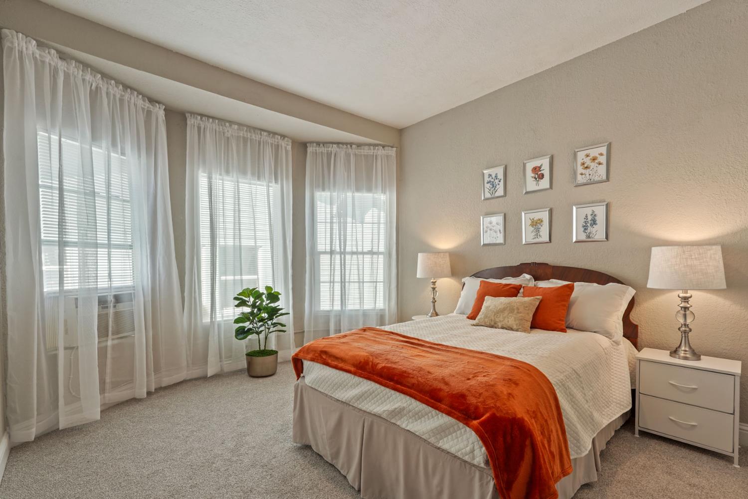 715 North Sutter Street Stockton, CA 95202 - Photo 40 of 51 a bedroom with a balcony and large bed