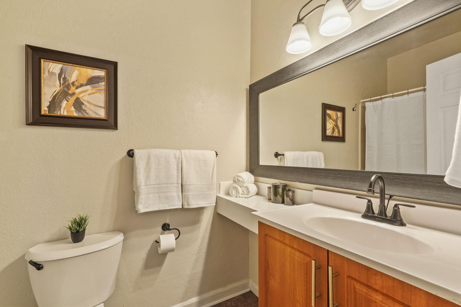 715 North Sutter Street Stockton, CA 95202 - Photo 42 of 51 a bathroom with a granite countertop sink mirror and toilet