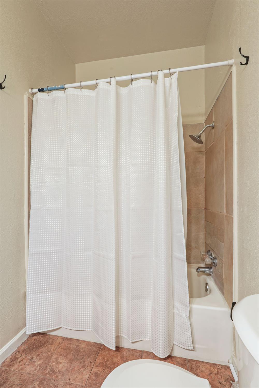 715 North Sutter Street Stockton, CA 95202 - Photo 43 of 51 a bathroom with a shower curtain and a sink