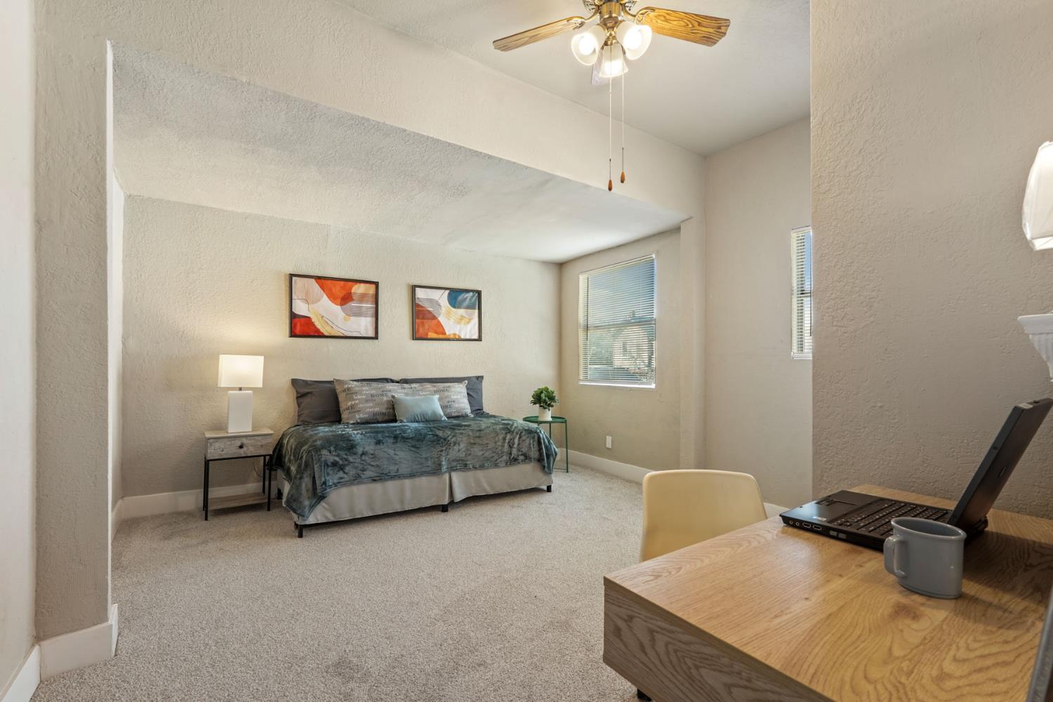 715 North Sutter Street Stockton, CA 95202 - Photo 44 of 51 a bedroom with a bed and a chandelier