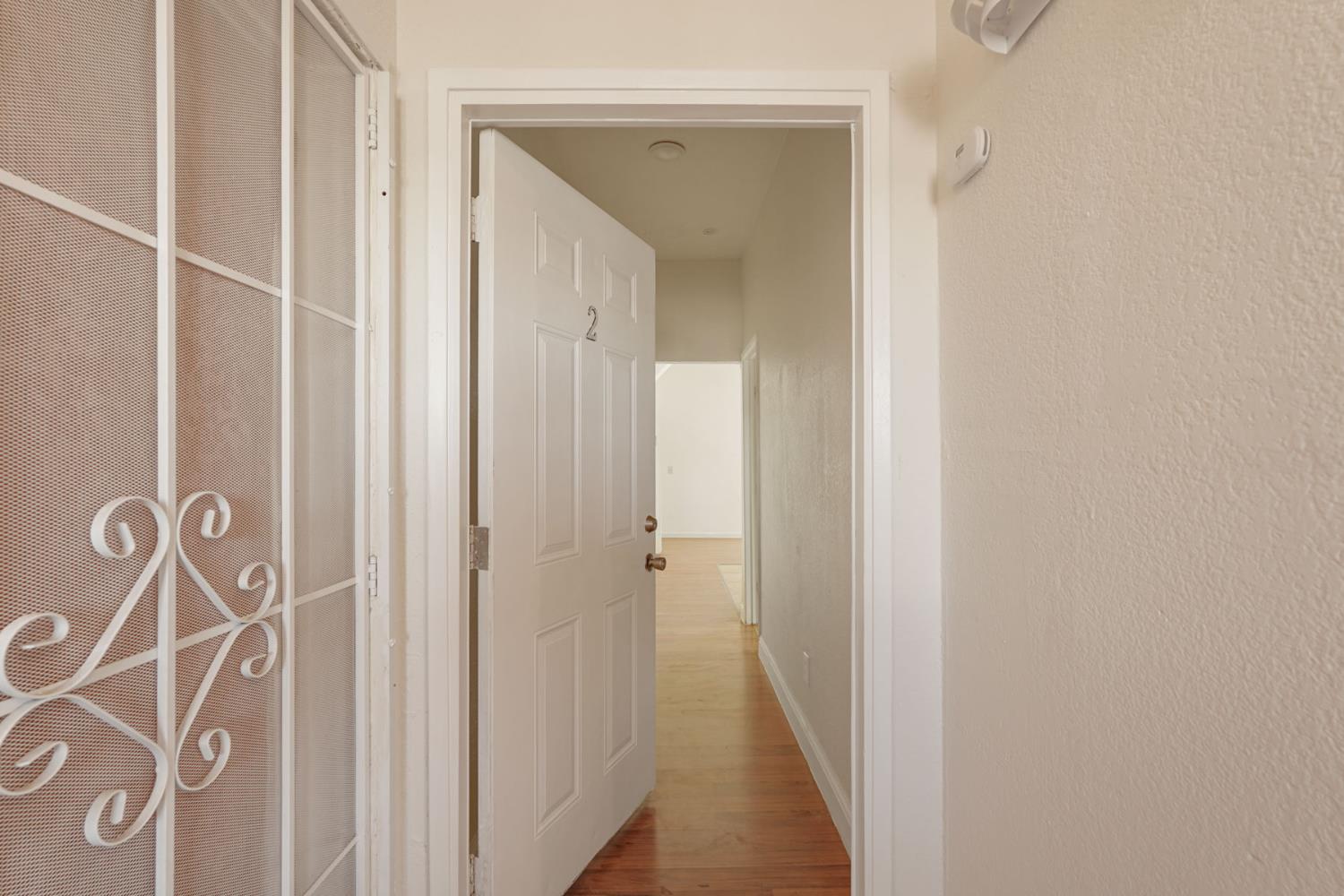 715 North Sutter Street Stockton, CA 95202 - Photo 9 of 51 a view of a hallway with wooden floor
