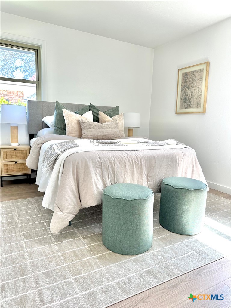 4412 Briar Cliff Road Temple, TX 76502 - Photo 17 of 28 a bedroom with a bed and a painting on the wall