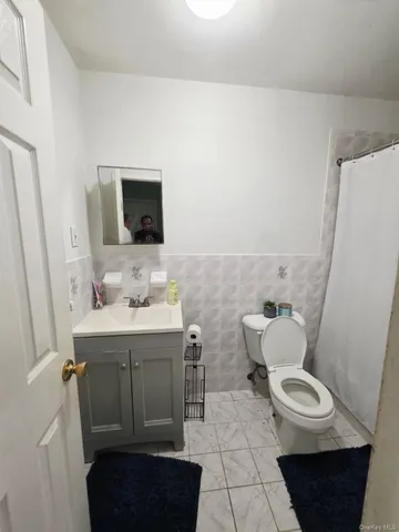 a bathroom with a sink a toilet a mirror and vanity
