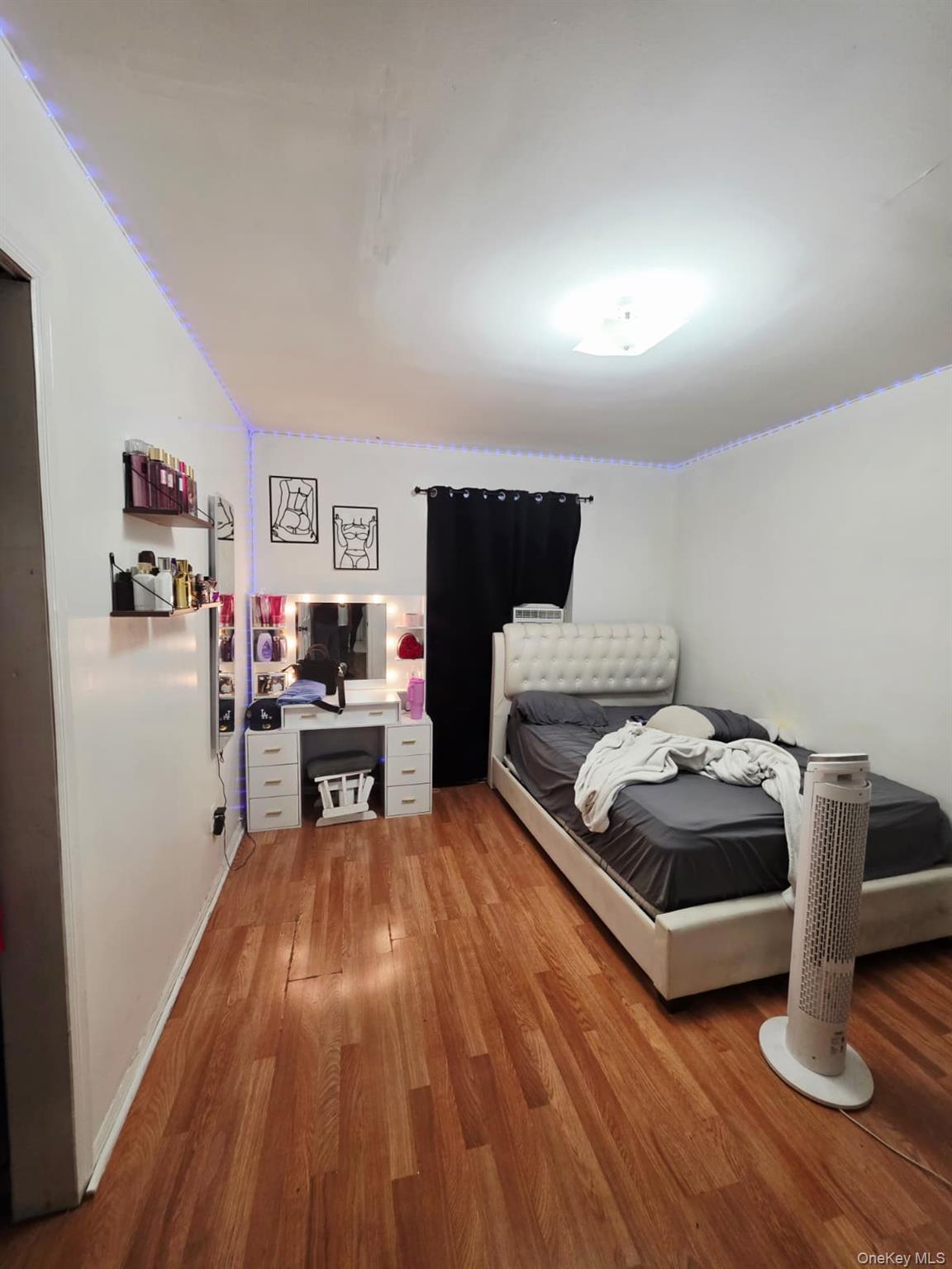 93-26 197th Street, Unit 3 Queens, NY 11423 - Photo 8 of 9 a living room with furniture and a wooden floor