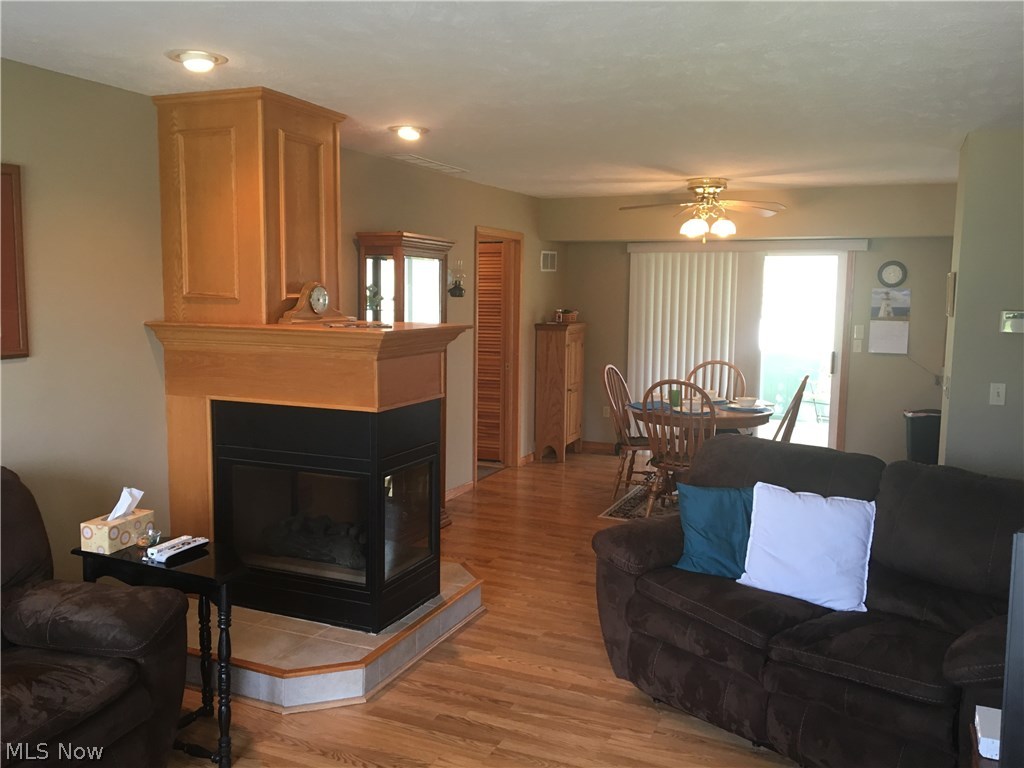 3161 Bates Road Madison, OH 44057 - Photo 6 of 32 Great living room with gas fireplace flows into the dining area