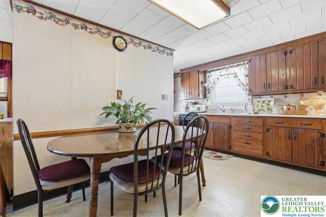 a dining room with furniture a window and a chandelier