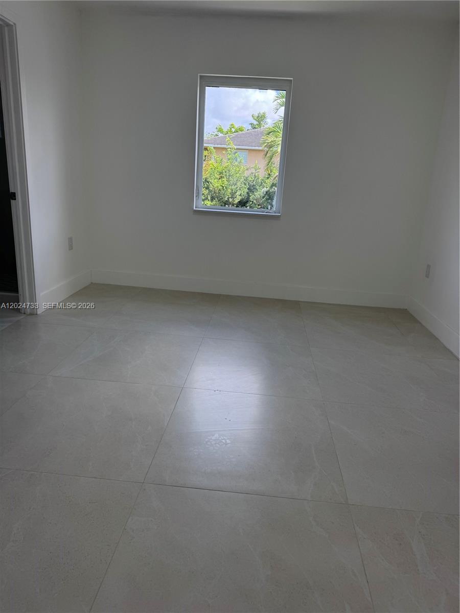 3305 Southwest 28th Street, Unit 3305 Miami, FL 33133 - Photo 9 of 17 an empty room with windows