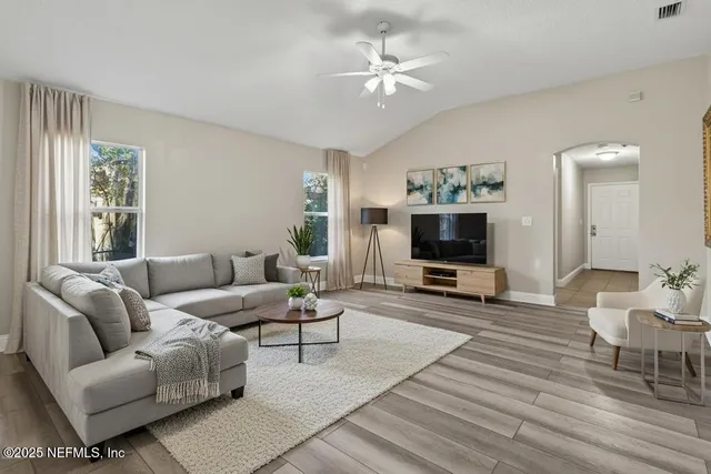 a living room with furniture and a flat screen tv