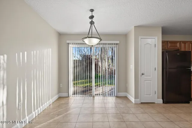 a view of a room with wooden floor and windows