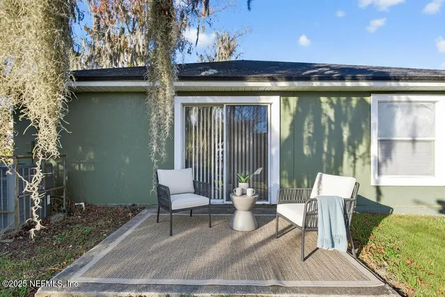 a patio with yard and outdoor seating