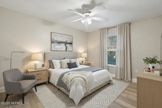 a bedroom with a large bed and a chandelier