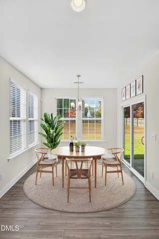 a dining room with furniture and wooden floor