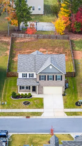 an aerial view of residential houses with outdoor space and street view