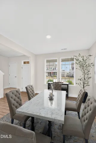 a view of a dining room with furniture and a large window