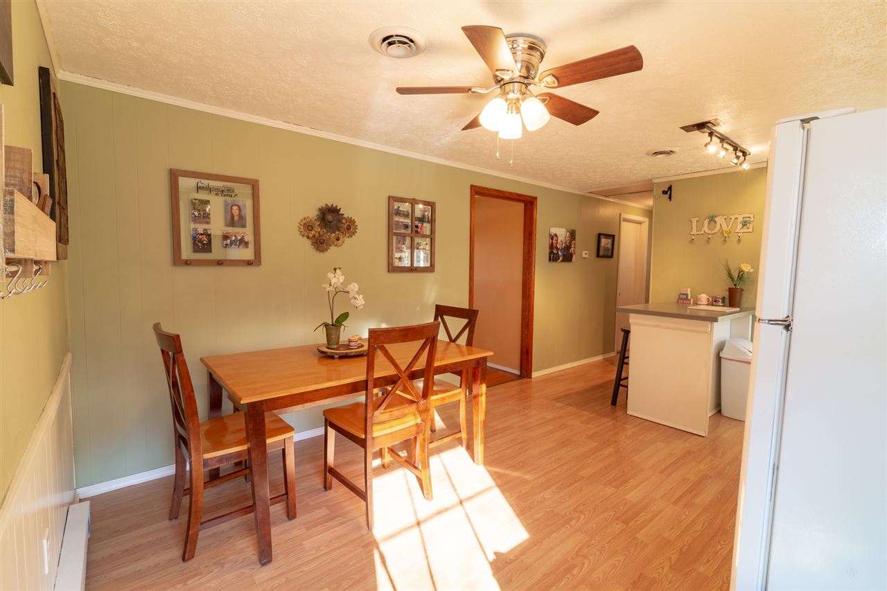 3391 Oak Ridge Road Mount Crawford, VA 22841 - Photo 7 of 27 a view of a dining room with furniture and a chandelier fan