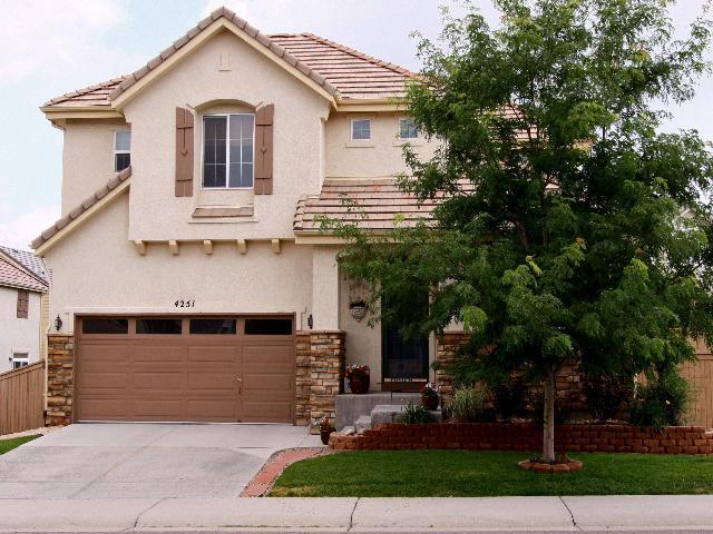 4251 Cliffrose Lane Highlands Ranch, CO 80130 - Photo 1 of 1 a front view of a house with a yard