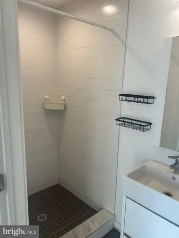 a bathroom with a sink and shower