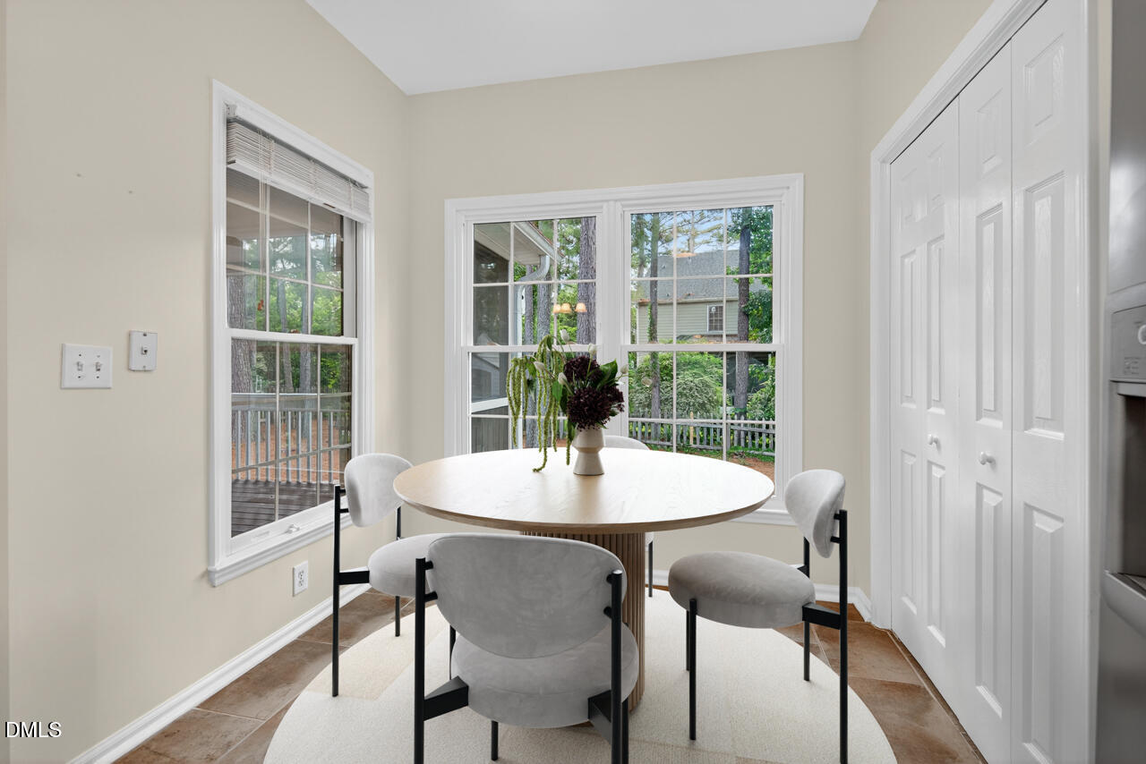 8825 Kirkstall Court Raleigh, NC 27615 - Photo 11 of 49 a view of a dining room with furniture window and wooden floor