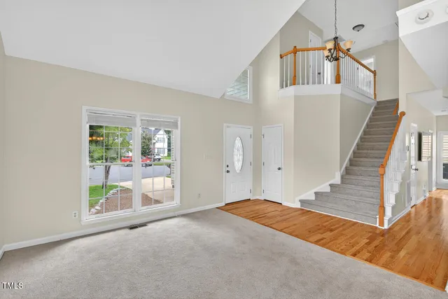 a kitchen with granite countertop a refrigerator stove top oven and cabinets