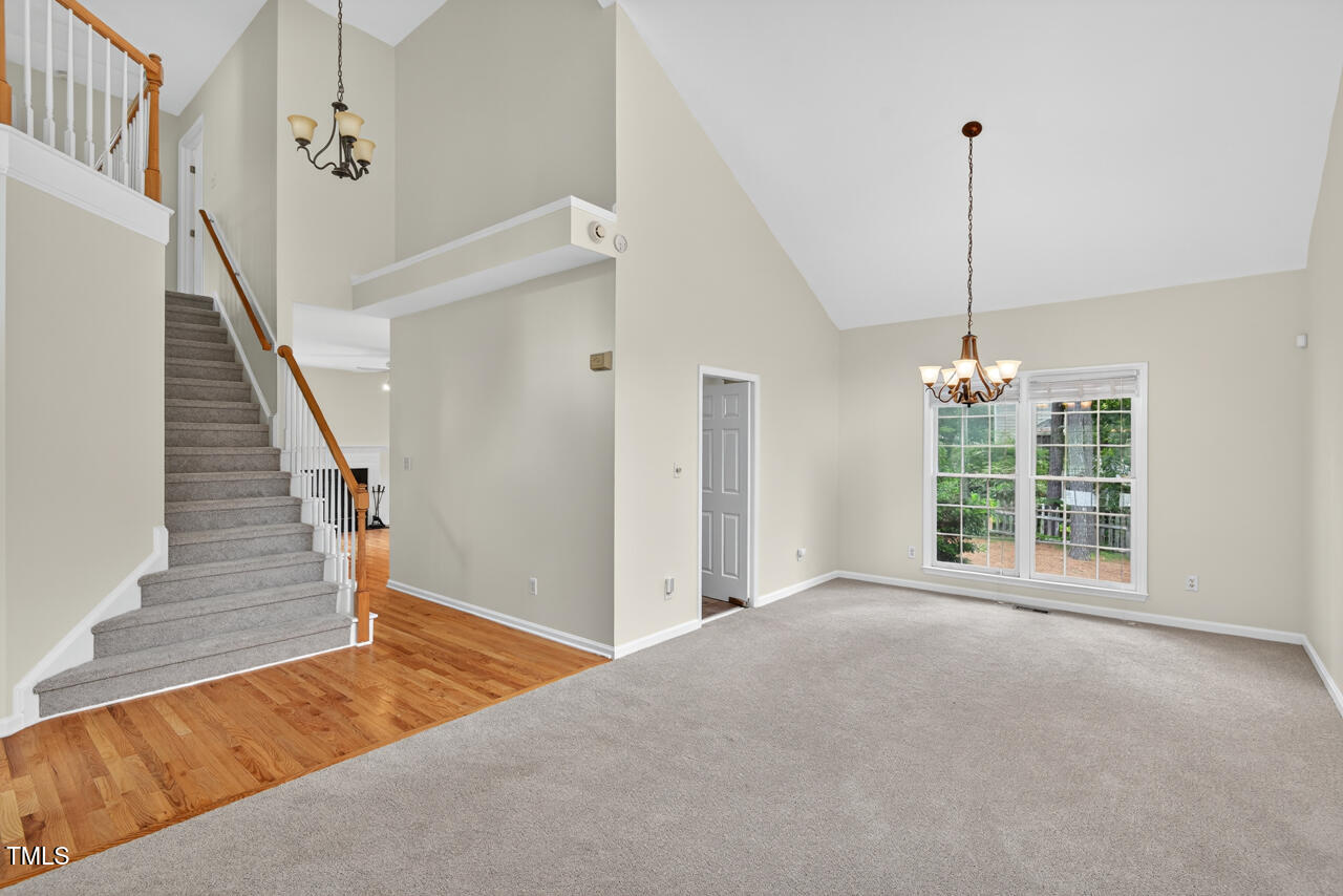 8825 Kirkstall Court Raleigh, NC 27615 - Photo 14 of 49 a view of a room with wooden floor and windows
