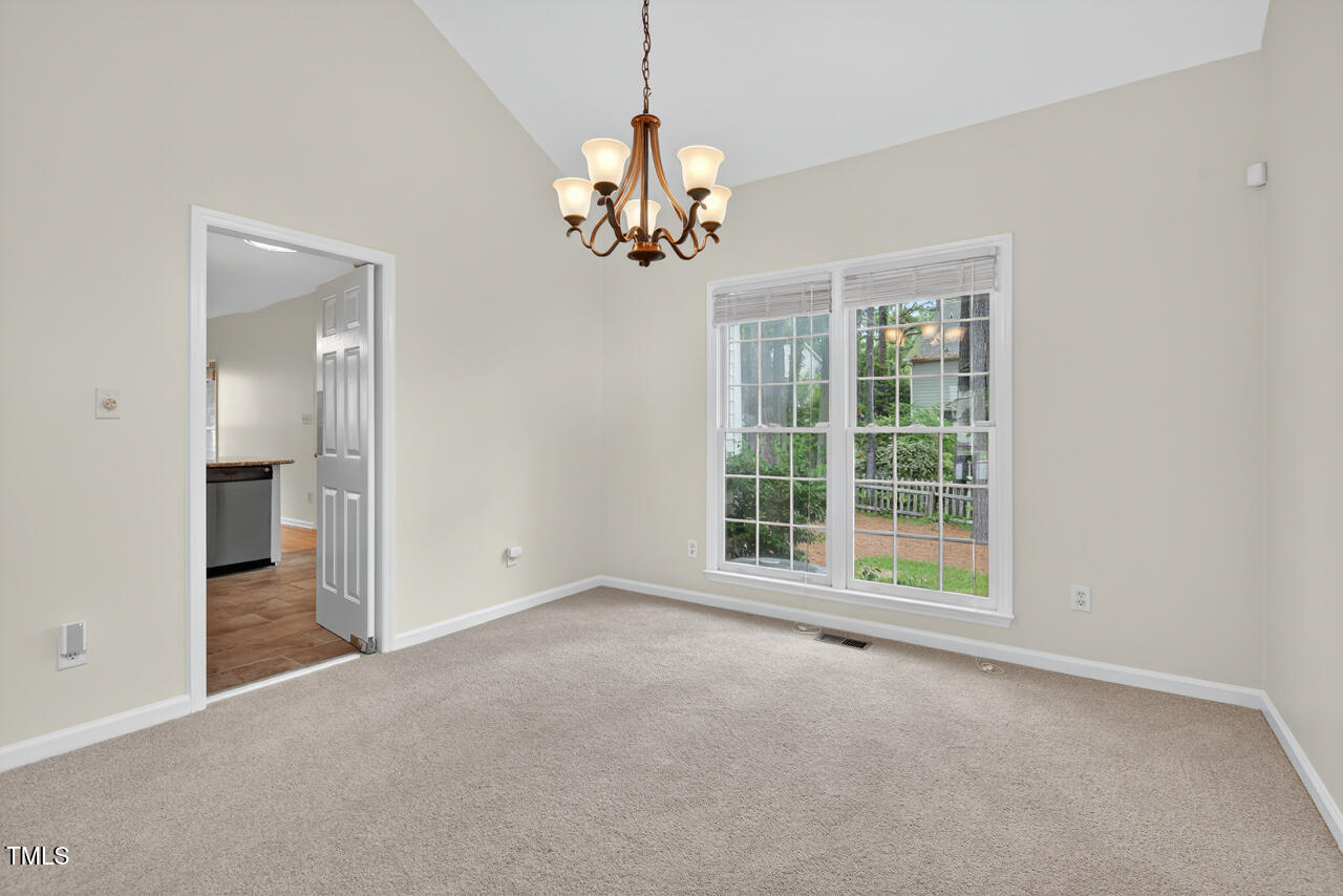 8825 Kirkstall Court Raleigh, NC 27615 - Photo 15 of 49 a view of an empty room with a window