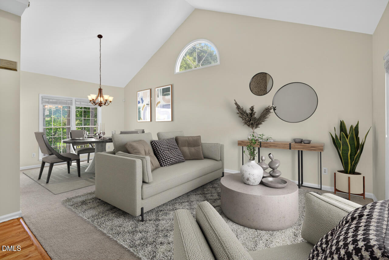 8825 Kirkstall Court Raleigh, NC 27615 - Photo 3 of 49 a living room with furniture a table and a chandelier