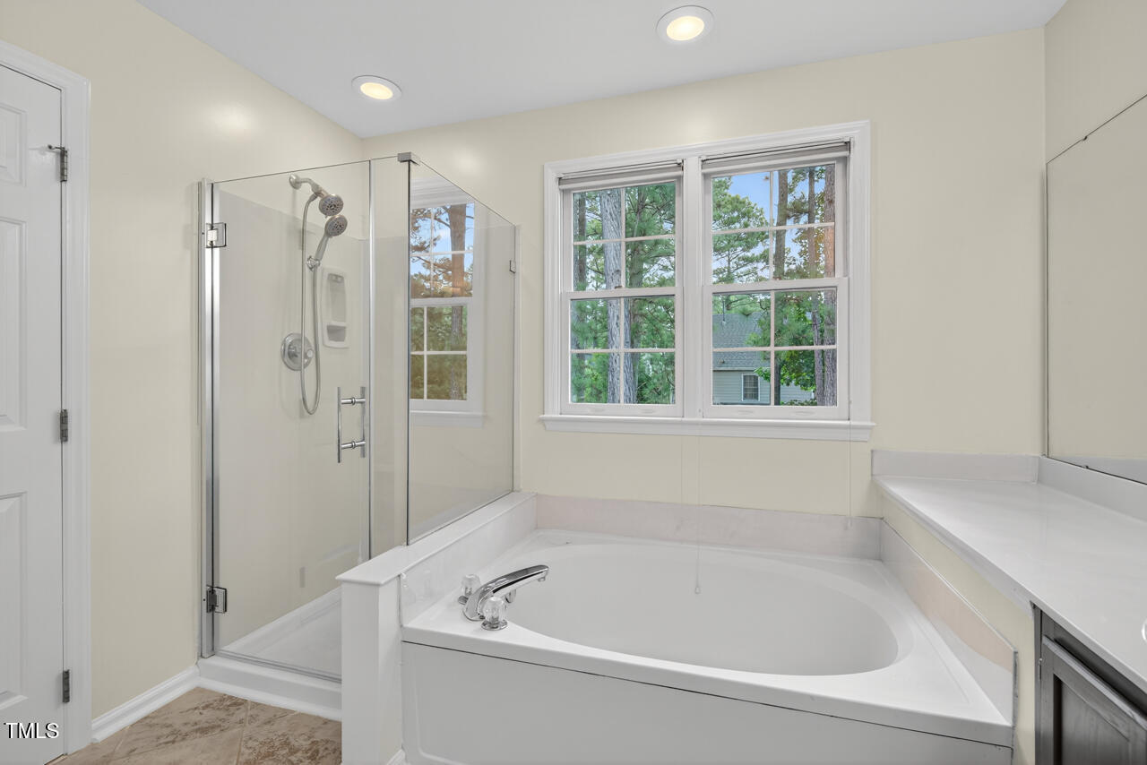 8825 Kirkstall Court Raleigh, NC 27615 - Photo 31 of 49 a white bath tub sitting next to a window