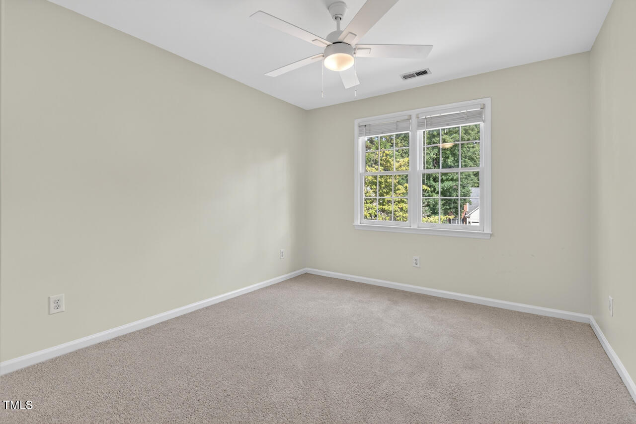8825 Kirkstall Court Raleigh, NC 27615 - Photo 32 of 49 an empty room with a window and a fan