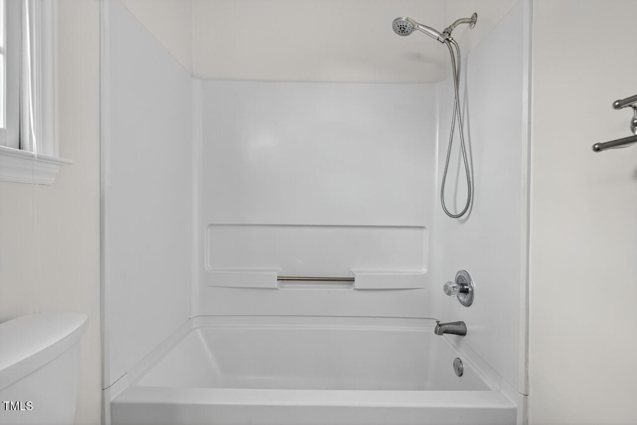 8825 Kirkstall Court Raleigh, NC 27615 - Photo 36 of 49 a bathroom with a bath tub with a shower
