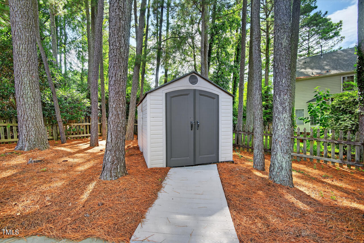8825 Kirkstall Court Raleigh, NC 27615 - Photo 43 of 49 a front view of a house with a yard and trees