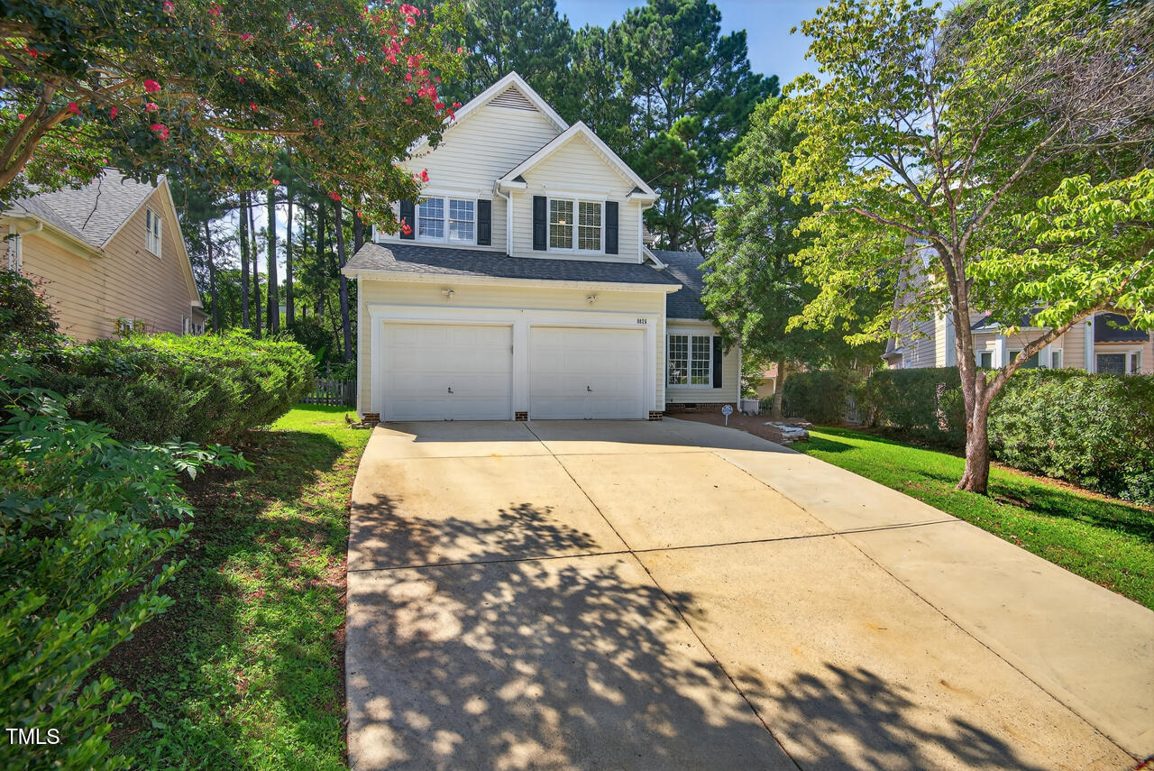 8825 Kirkstall Court Raleigh, NC 27615 - Photo 48 of 49 a front view of a house with a yard and garage