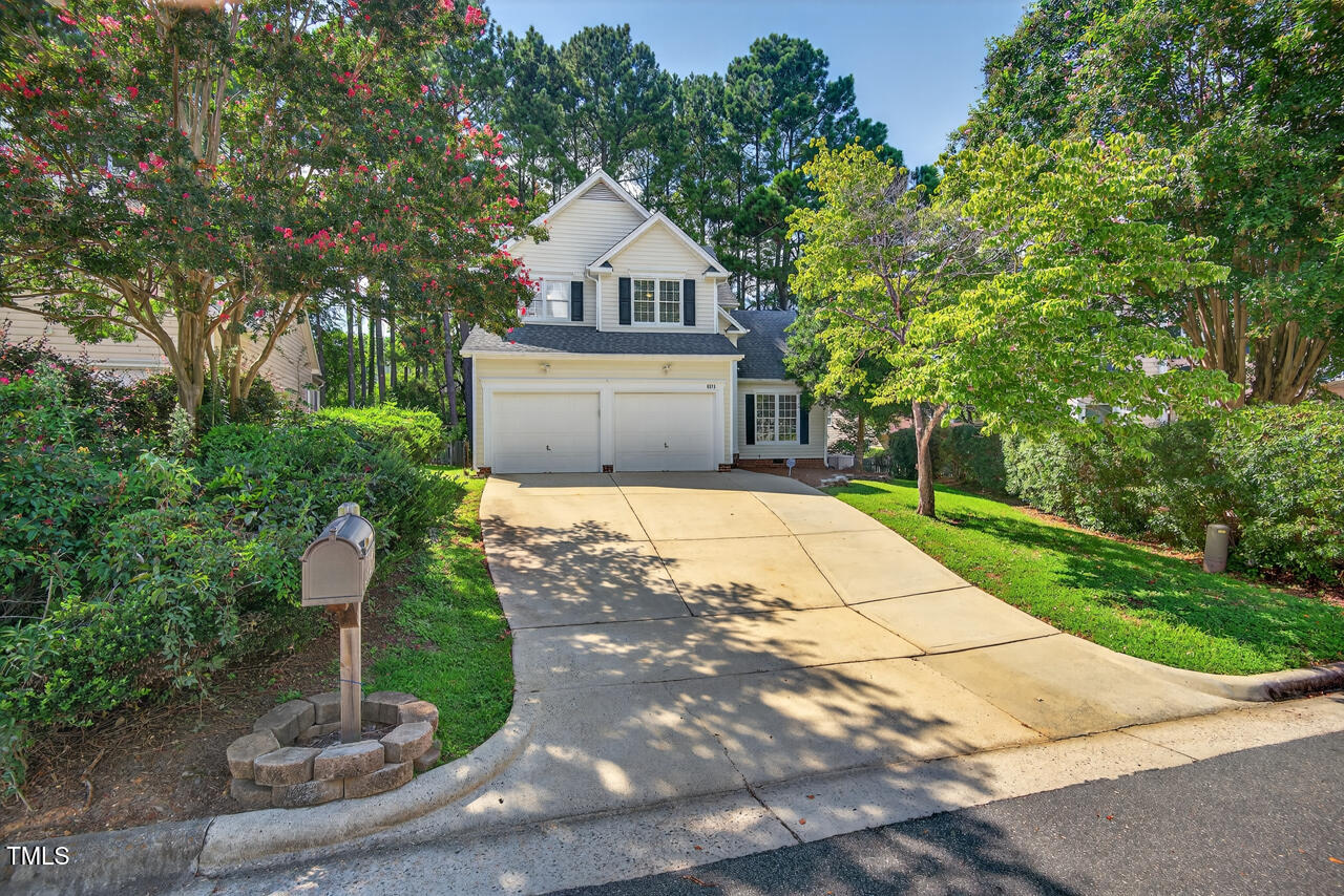 8825 Kirkstall Court Raleigh, NC 27615 - Photo 49 of 49 a front view of a house with a yard and trees