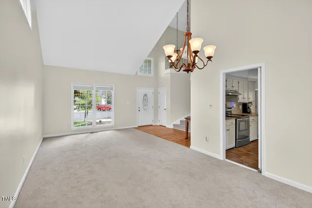 a view of empty room with wooden floor and fireplace
