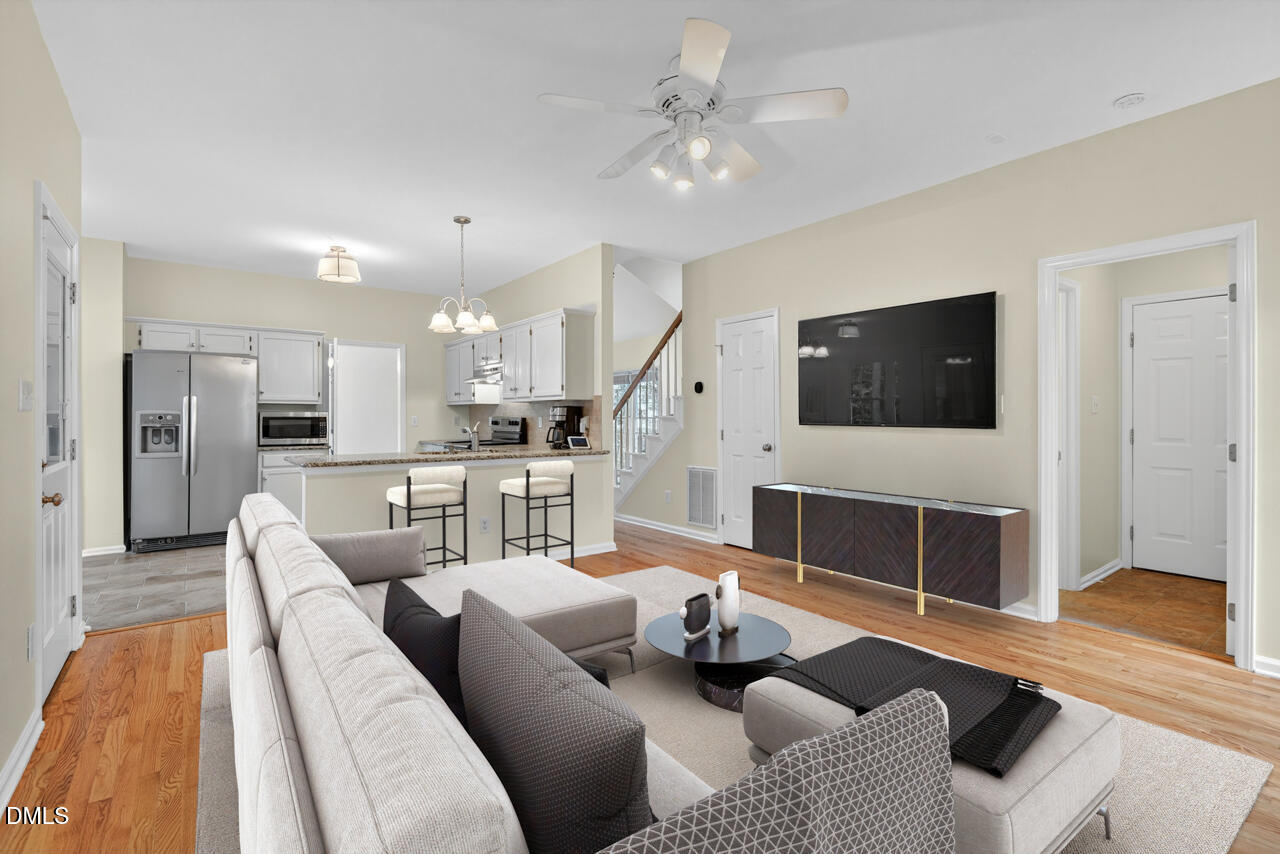 8825 Kirkstall Court Raleigh, NC 27615 - Photo 7 of 49 a living room with furniture and a flat screen tv
