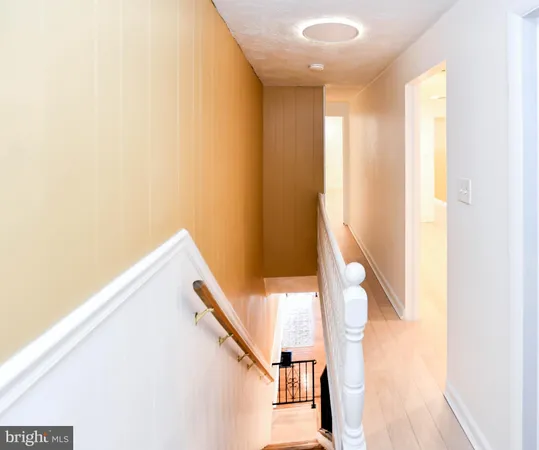 a view of staircase with white walls and a window