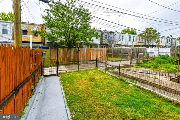 a view of a garden with wooden fence