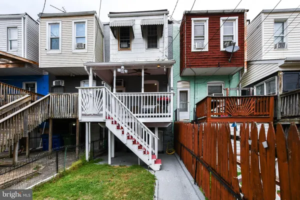 a view of a house with brick walls and a deck