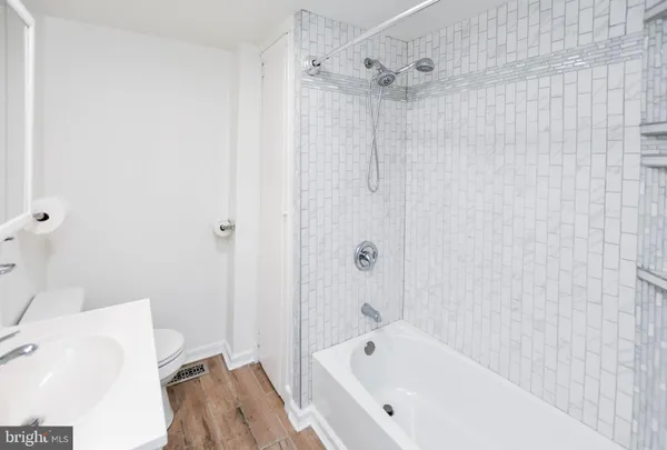 a bathroom with a bathtub and shower