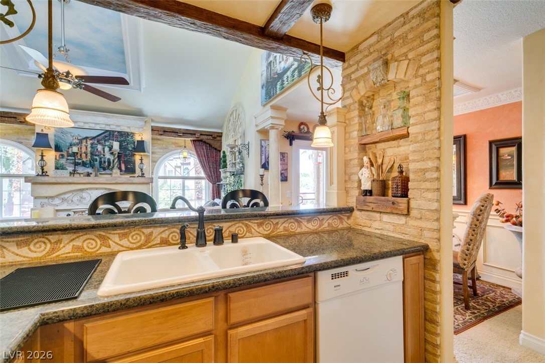 9325 West Desert Inn Road, Unit 244 Las Vegas, NV 89117 - Photo 25 of 55 A well-appointed kitchen showcasing a spacious sink, a dishwasher, and a blend of granite and wood finishes.