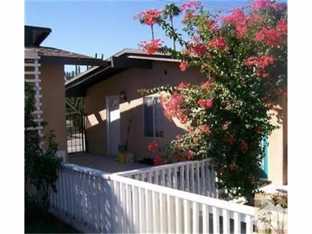 a view of a house with wooden fence
