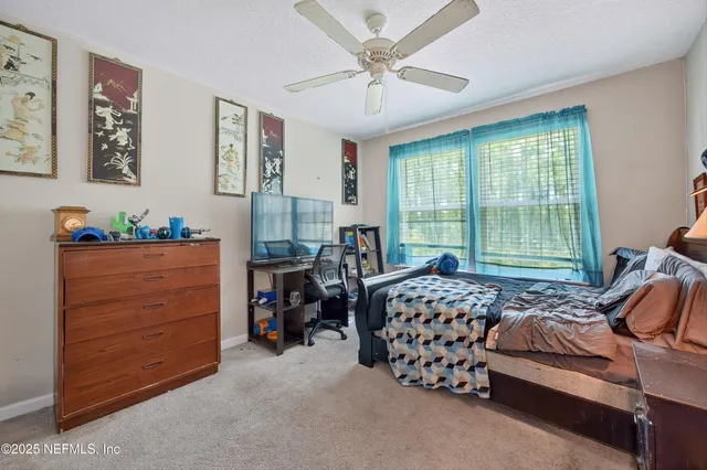 a bedroom with bed and a window