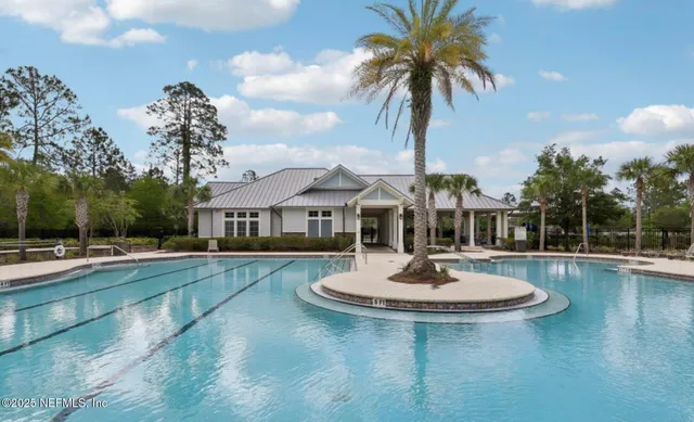 a swimming pool with a yard in front of it
