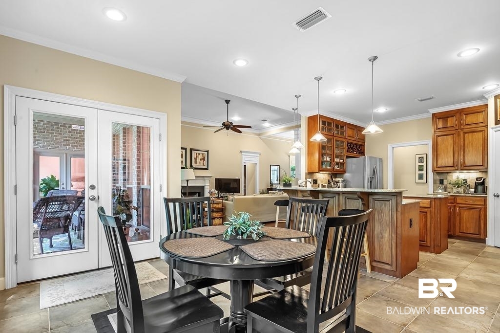 29976 Dolive Ridge Daphne, AL 36527 - Photo 21 of 58 Tiled dining space featuring french doors, ornamental molding, and ceiling fan