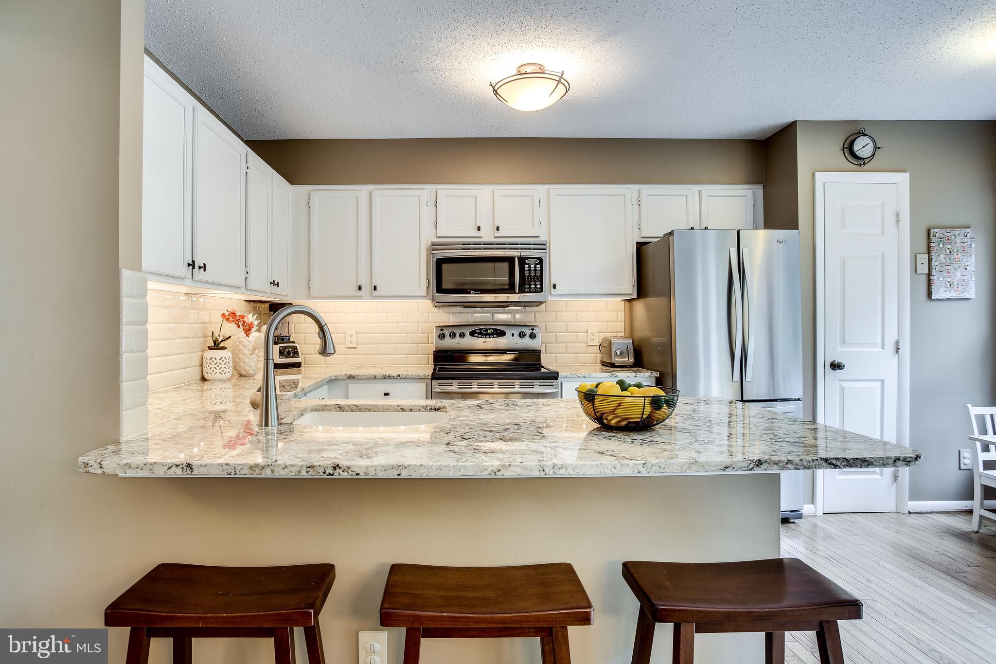 1630 Oak Spring Way Reston, VA 20190 - Photo 27 of 74 Breakfast bar & stunning granite counters!