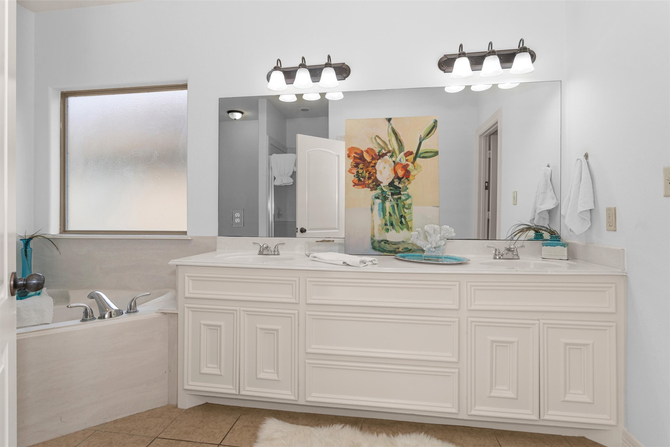 111 Cove Place Montgomery, TX 77356 - Photo 12 of 29 a bathroom with a sink vanity and a mirror