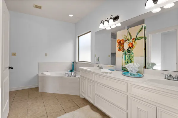 a bathroom with a sink vanity and a mirror